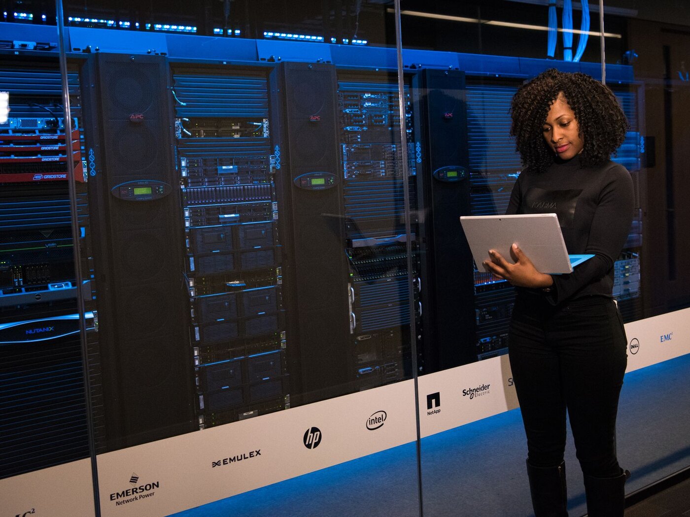 Technology engineer working beside server racks in a data center
