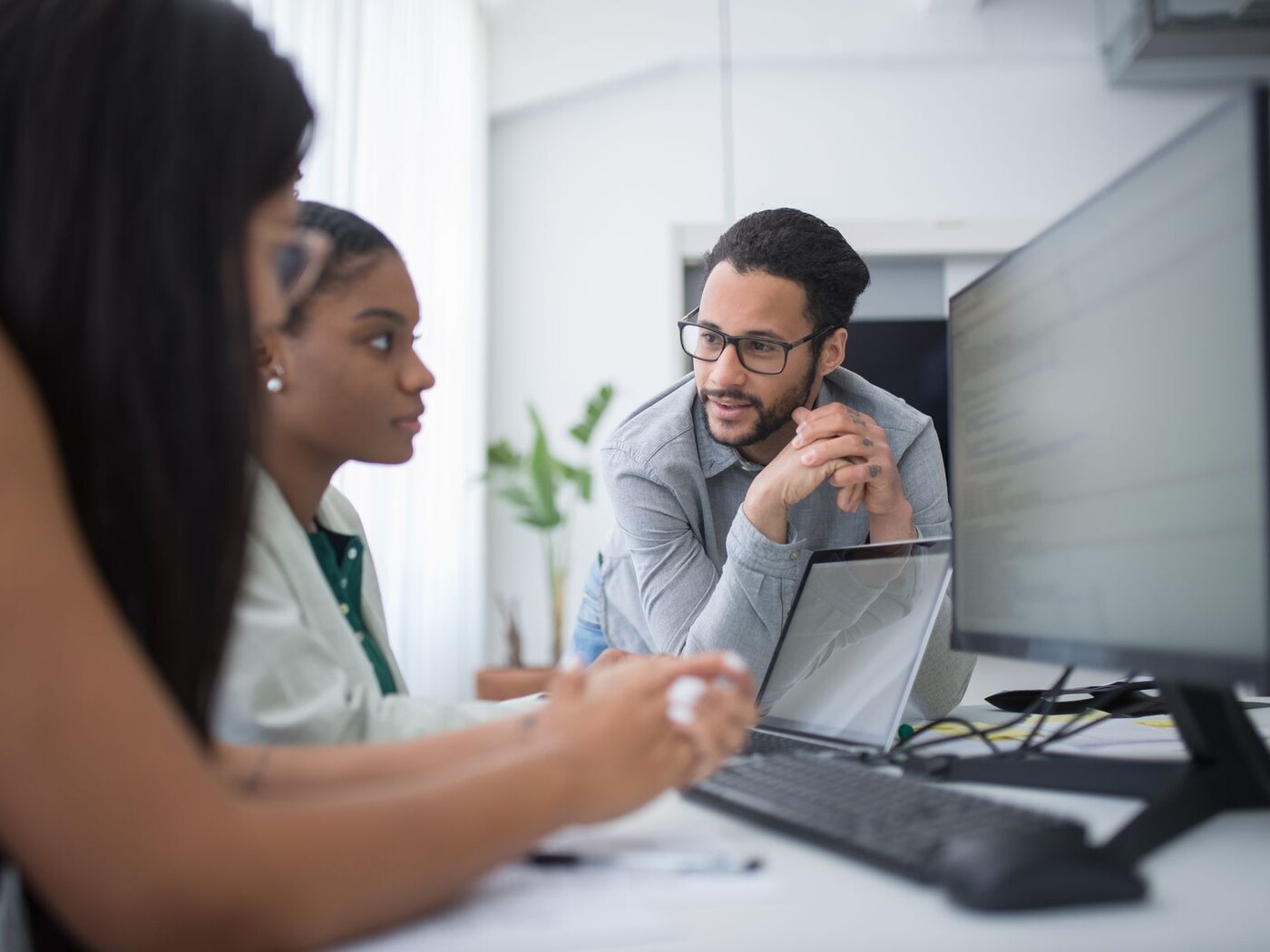 Business and technology professionals reviewing a digital platform together